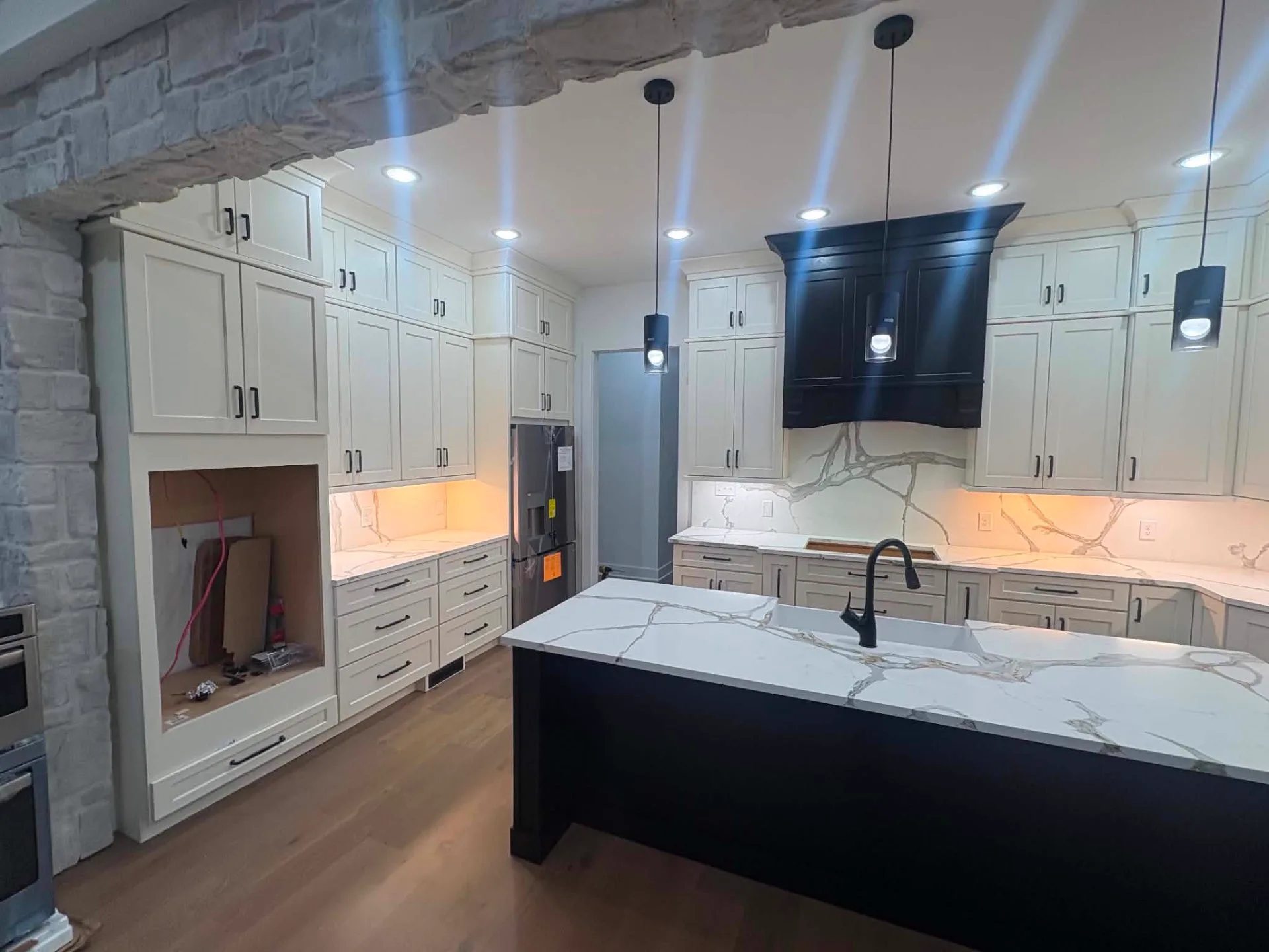 Stone Arch, Black Hood — Kitchen cabinetry installed by Howard's Cabinet Installation